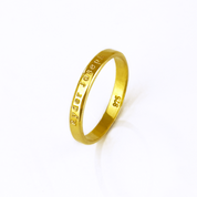 Custom 3mm gold engraved ring with text personalization shown on white background. Slim and minimalist unisex band designed for engraving names, dates, or meaningful phrases. Perfect as a wedding band, promise ring, or everyday stacking ring, this dainty engraved band is available in sterling silver, gold, or rose gold. A meaningful keepsake gift crafted with precision engraving and timeless design for couples or individuals.