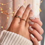 A person wears three 3 mm birthstone stacking rings in gold. Sterling silver or gold vermeil tiny round birthstone rings, custom bezel set birthstone ring set for mom, kids birthstone ring set for mother, mother's day, mom of 2, 3, 4, 5, 6, custom family birthstone jewelry for mom