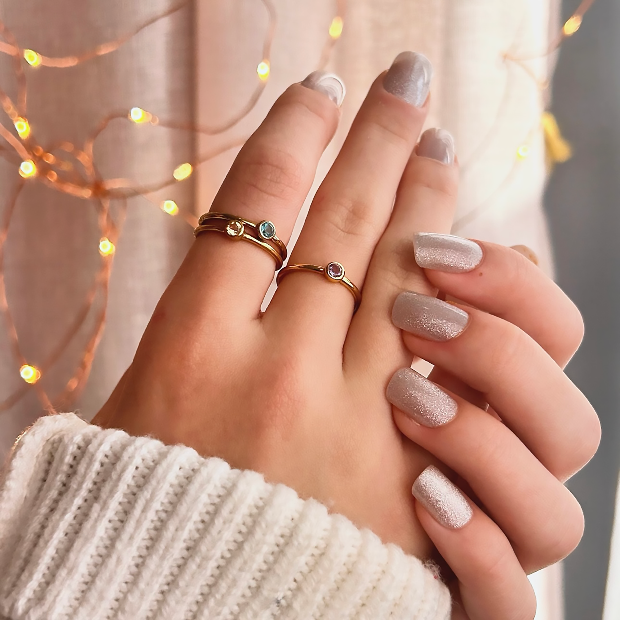 A person wears three 3 mm birthstone stacking rings in gold. Sterling silver or gold vermeil tiny round birthstone rings, custom bezel set birthstone ring set for mom, kids birthstone ring set for mother, mother's day, mom of 2, 3, 4, 5, 6, custom family birthstone jewelry for mom