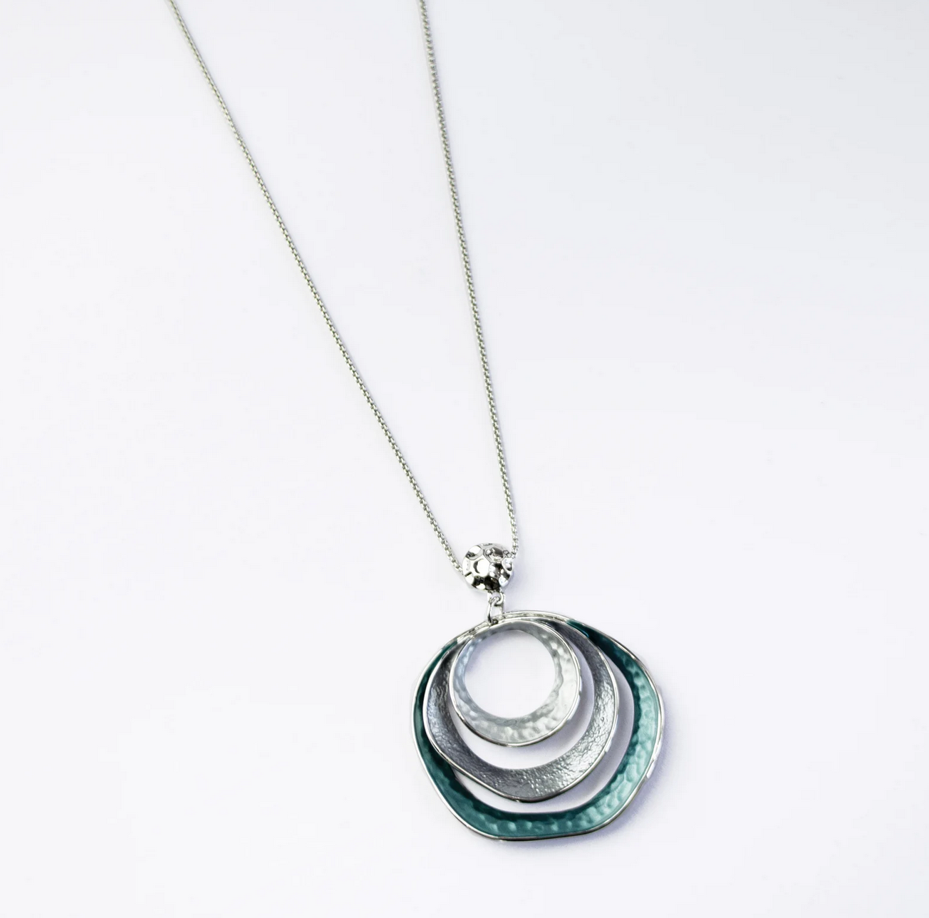 beautiful three-ring circles statement necklace with silver and blue tones. Necklace is made with a steel cable chain and a zinc alloy pendant with a galvanic finish. boho necklace, boho jewelry, bohemian statement jewelry
