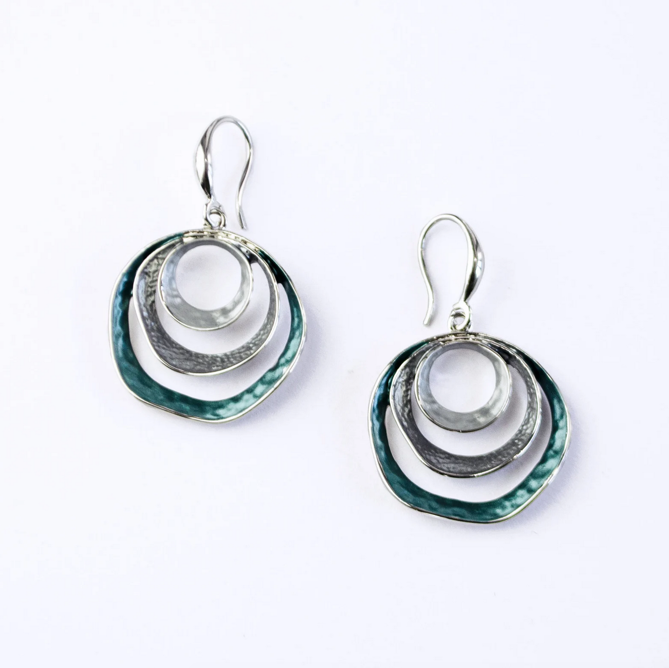 beautiful three-ring circles statement earrings with silver and blue tones on white background