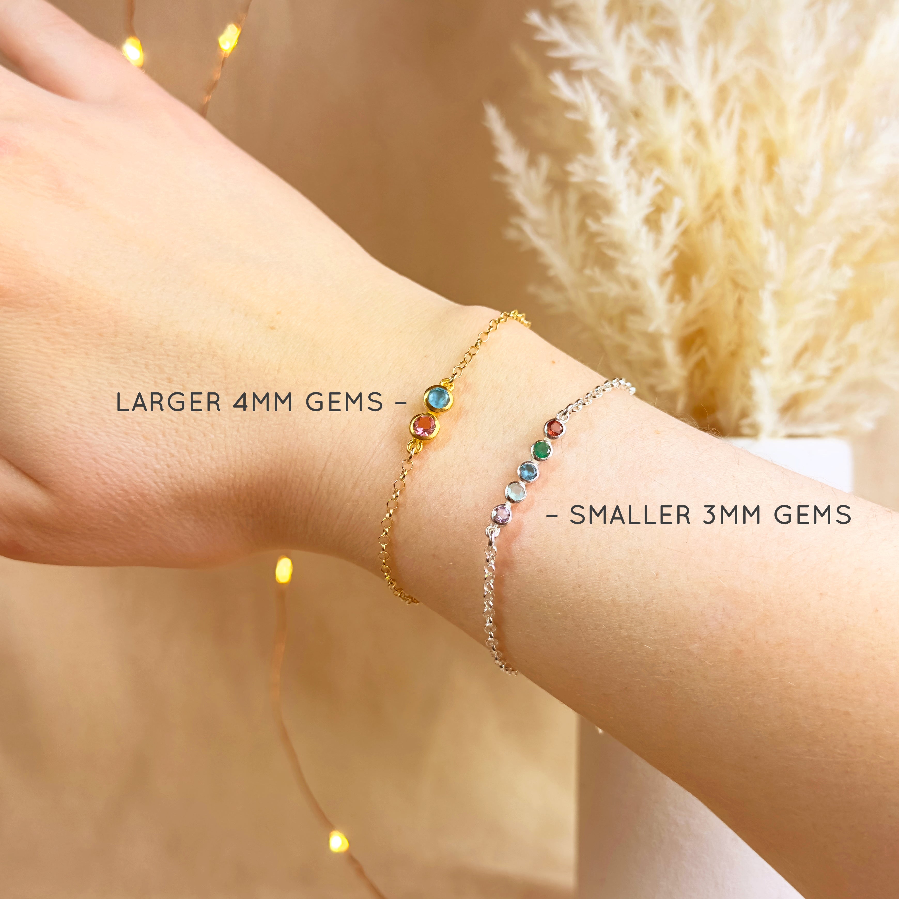 Two tiny birthstone bar bracelets on wrist, showing size comparison of larger 4mm gemstones and smaller 3mm gemstones. Gold bracelet features bold gems like March Aquamarine and July Ruby Quartz, while sterling silver bracelet shows multiple months including January Garnet, May Emerald, September Sapphire, and December Turquoise. A dainty personalized bracelet gift for mom, daughter, or grandma, perfect for birthdays, Mother’s Day, or Christmas.