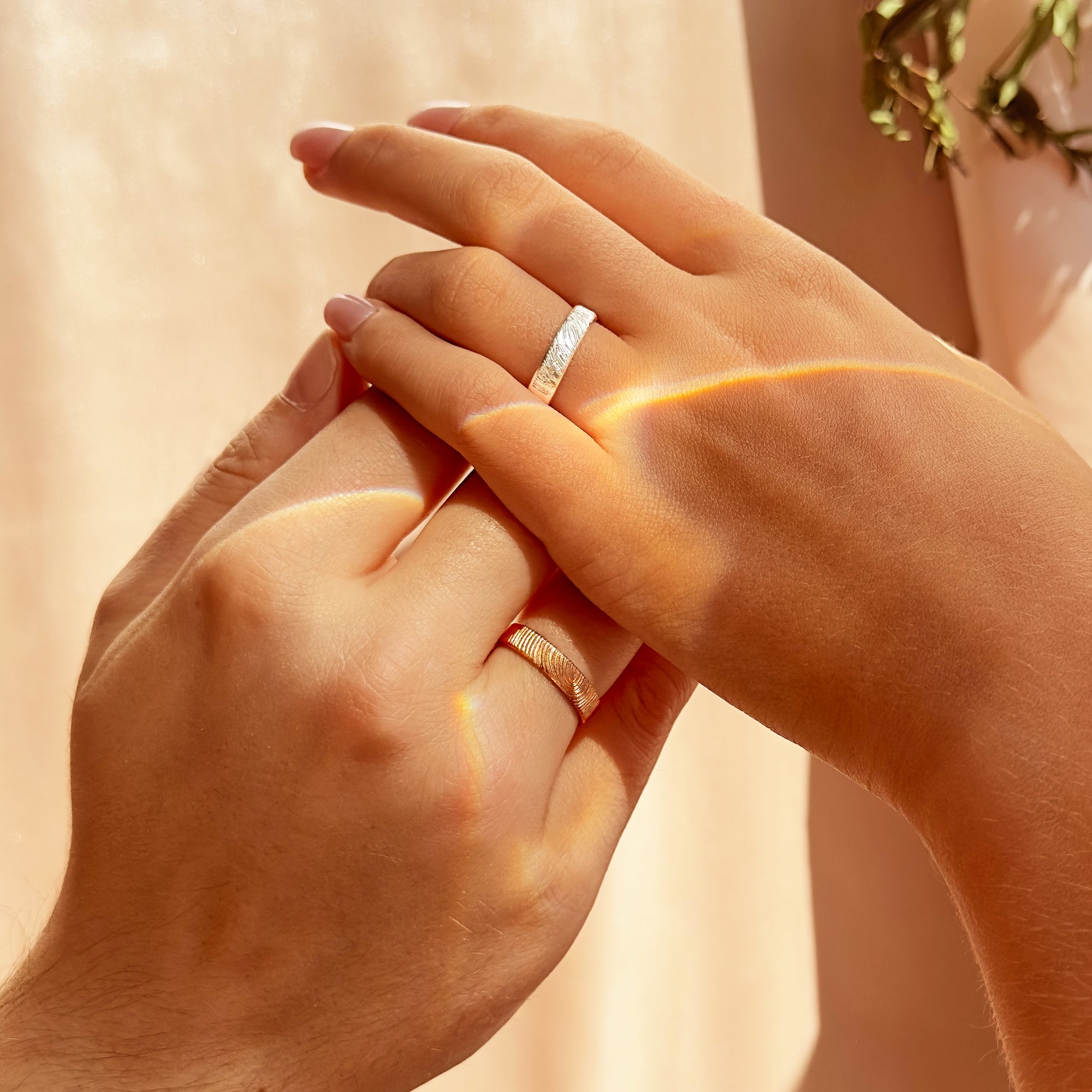His and hers engraved fingerprint rings worn as matching couple bands, featuring a slim 4mm unisex design in sterling silver and gold. Ideal as personalized wedding bands, promise rings, or anniversary gifts, these custom engraved rings capture fingerprints, names, or messages. Handcrafted from quality materials, they make meaningful unisex jewelry for both men and women.