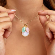 Custom birthstone mom necklace shown on model, featuring a dainty gold-filled chain with three bezel-set teardrop charms—a larger milky white center stone with aqua green and blush pink birthstones layered above. Personalized family necklace for moms with children’s birthstones; minimalist, everyday style that layers well. Elegant Mother’s Day, Christmas or birthday gift, handcrafted and gift-ready, customizable with additional stones or initials for a meaningful keepsake.