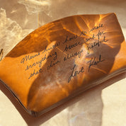 Leather cosmetic bag engraved with custom handwriting message, creating a one-of-a-kind personalized makeup pouch. Perfect for weddings, anniversaries, or memorial gifts. Spacious and durable design with zipper closure and inside pocket, making it an ideal everyday bag for makeup storage or travel. A heartfelt and unique keepsake for loved ones.