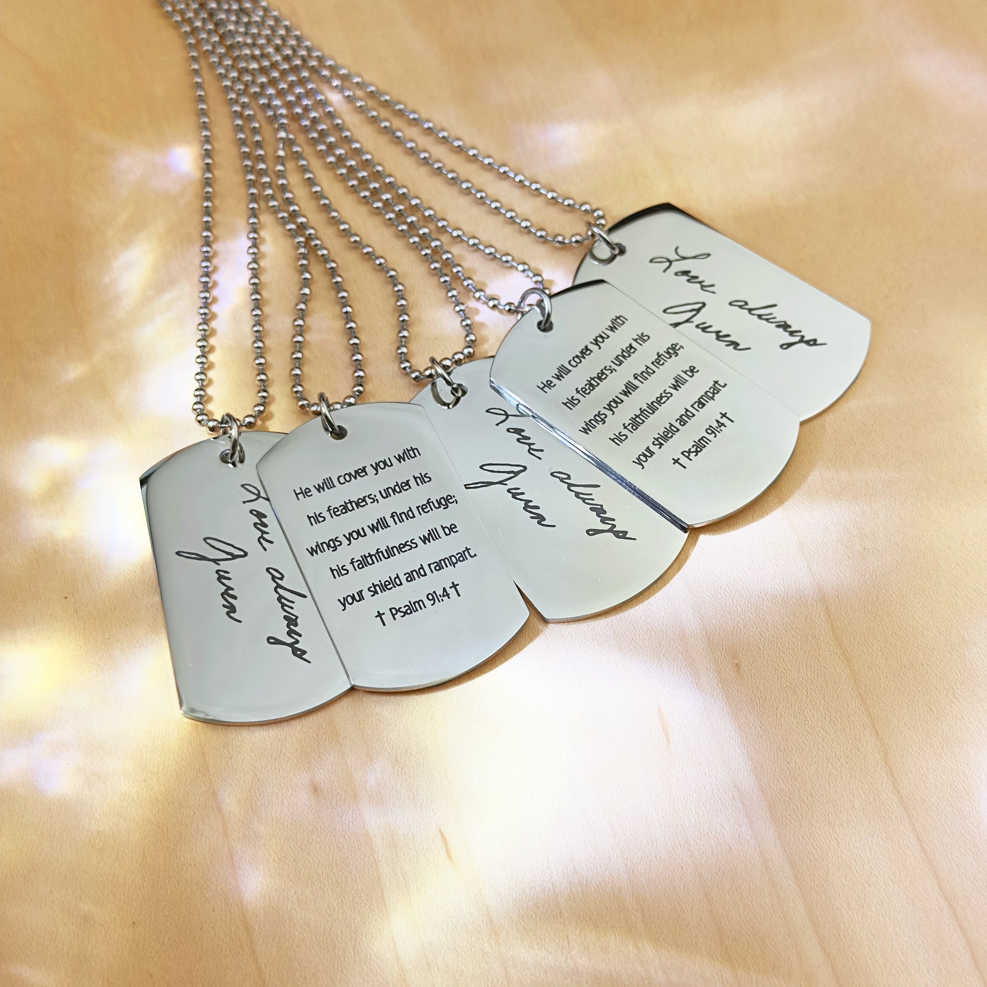 Custom engraved stainless steel dog tag necklaces displayed with personalized messages and names, military-style design, unisex jewelry for men or women, ideal personalized gift for him for Christmas, birthdays, anniversaries, or Father’s Day, durable quality pendant with optional front and back engraving, ball chain style necklace with brushed finish, meaningful keepsake jewelry accessory designed to last a lifetime, handcrafted with precision, shipped in gift-ready packaging for easy gifting.