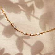 Artful close-up of the delicate chain and morse code beads casting organic shadows, emphasizing minimalist texture and craftsmanship. The hidden message necklace is lightweight, modern, and adjustable 16–18 inches, making it ideal for daily layering. Offered in gold filled and sterling silver, this secret message jewelry suits understated style seekers who want meaningful personalization in a refined, subtle silhouette.