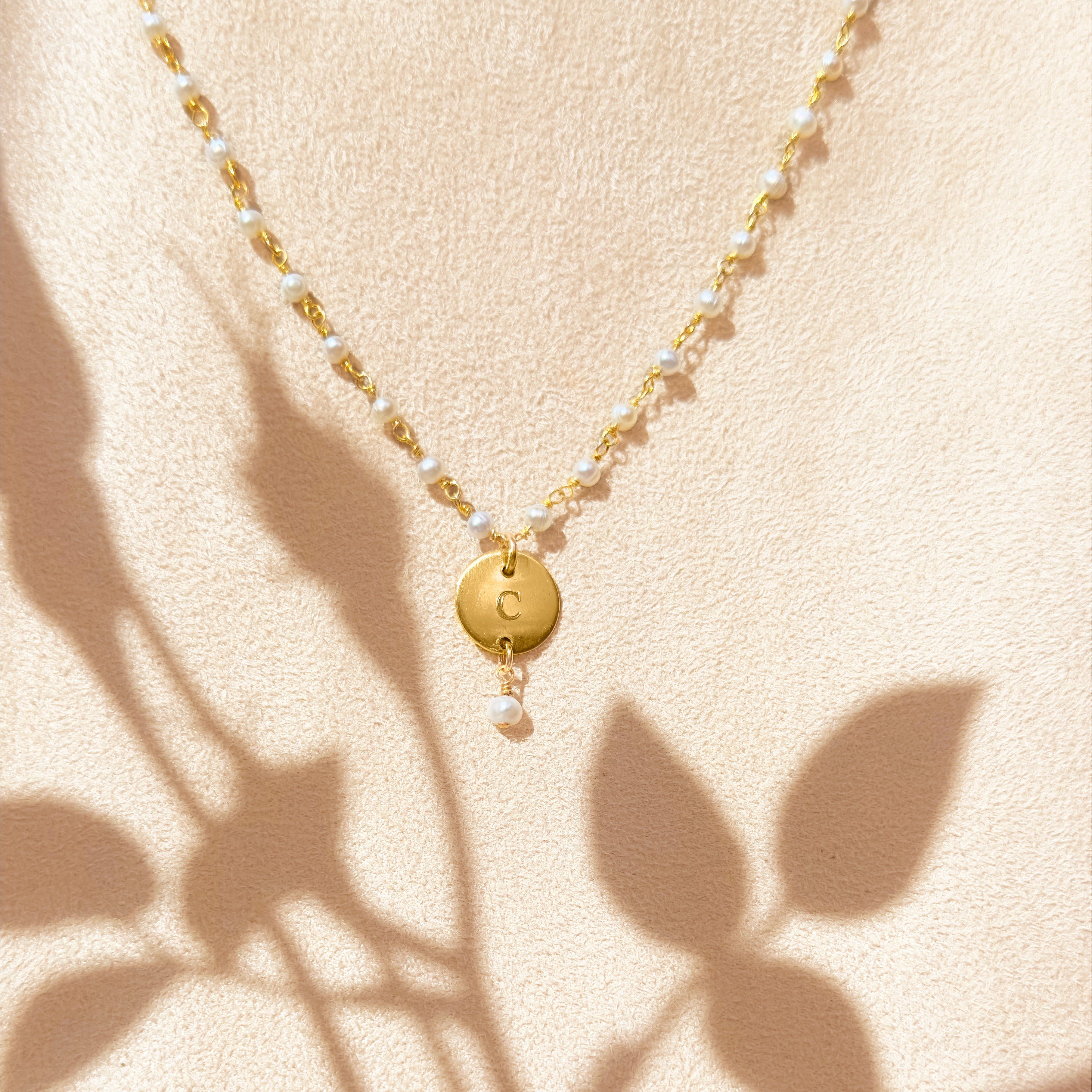 Gold wire wrapped pearl bracelet with disc engraved with the letter C with dangling pearl on a beige background. Dangling pearl charm optional. Nature inspired jewelry, gift for mom nature bracelet, dainty bracelet, charm bracelet