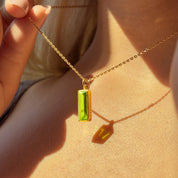Peridot August birthstone baguette necklace on a dainty 18K vermeil gold chain, shown with side name engraving “Rebecca.” Personalized bar pendant, minimalist stacking jewelry, custom birth-month gift, everyday wear, bridesmaid and birthday present.