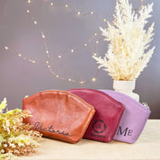 Set of three personalized leather cosmetic bags in honey brown, raspberry red, and lavender purple, each engraved with custom names and monograms. These stylish toiletry pouches feature a zippered closure and premium craftsmanship, perfect for bridesmaids, birthday gifts, or everyday travel organization. A versatile and elegant makeup bag collection for women who value personalization, durability, and timeless leather accessories.