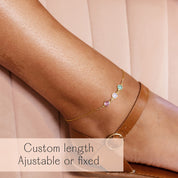 Personalized ankle bracelet with bezel-set gemstones in gold, shown on ankle with sandal strap. This elegant anklet is available in custom adjustable or fixed lengths and makes a meaningful jewelry gift for sisters, best friends, or loved ones. Ideal as a friendship anklet, matching anklet set, or thoughtful birthday, Christmas, or anniversary gift. Handmade in sterling silver, gold filled, or rose gold filled, this dainty ankle bracelet captures love, family, and friendship in a timeless keepsake.