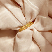 Close-up of a minimalist custom dog nose print ring resting on satin, highlighting the laser-engraved nose texture on a smooth 4mm comfort-fit band. A modern pet memorial ring for dog moms and dads, available in silver, gold, and rose gold. Ideal sympathy gift for loss of pet, unique dog gift for Christmas, or meaningful everyday keepsake with optional inside engraving.