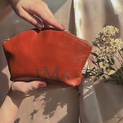 Personalized natural leather cosmetic bag for women with monogram initials—handmade zip pouch with durable lining and Italian zipper; customizable engraving, travel makeup bag, bridesmaid or mom gift, gift-ready by Danique Jewelry.