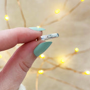 Model holding ring engraved with Til Death. Wedding Band. Custom Engraved, Name Engraving, Date Engraving, Coordinates Engraving, Initials, Short Quote, Secret Message, Love Note, Roman Numerals, Forever, Always, Promise ring, Soulmate, Best Friends, Family Bond, Anniversary Gift, Birthday Gift, Graduation Gift, Wedding Band, Couple Ring, Memorial Ring, valentine's day, Sentimental, Hidden Message, Minimalist Design, christmas, gift for husband, gift for wife