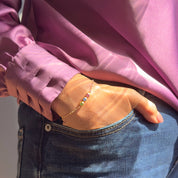 Tiny birthstone bar bracelet worn on wrist, featuring dainty gemstones set in a minimalist bar design with gold-filled chain. A meaningful personalized jewelry gift for mom, daughter, or grandmother, this delicate bracelet celebrates birthdays, Mother’s Day, anniversaries, or Christmas. Available in sterling silver or gold-filled finishes with 3mm or 4mm gemstones for a timeless and elegant look.