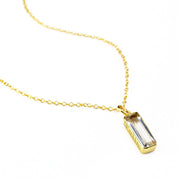 Gold filled single cable chain with vertical clear quartz april birthstone with secret engraving with classic font.