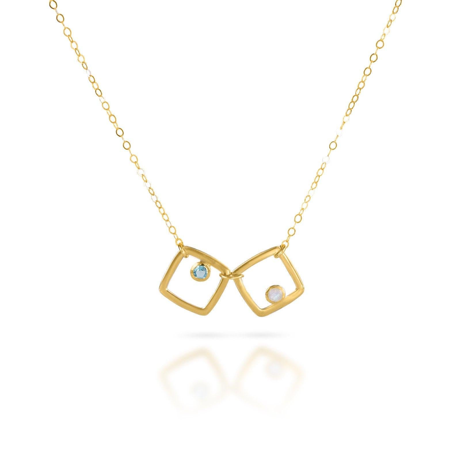 Single gold filled square geometric necklace with blue topaz and moonstone birthstones.