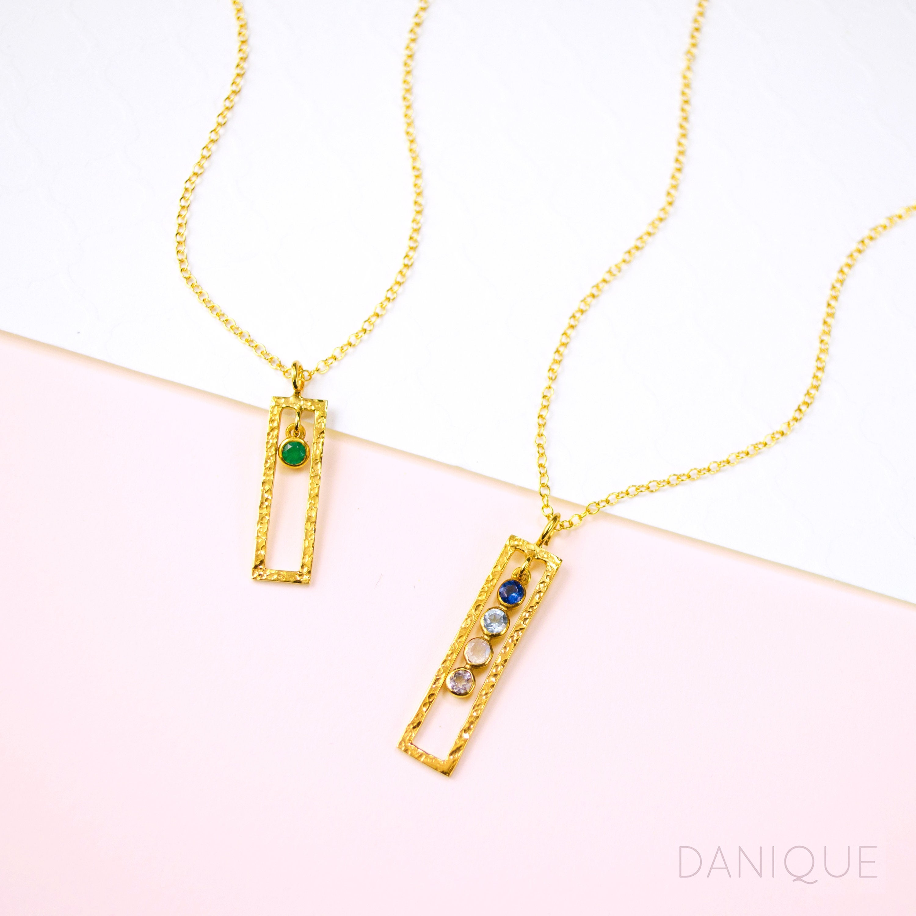A gold filled open frame green onyx birthstone necklace. Gold filled open frame necklace with four birthstones including kyanite, blue topaz, pink chalcedony, and purple amethyst.