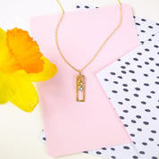 Single gold filled open frame necklace with peridot and aqua chalcedony birthstones.