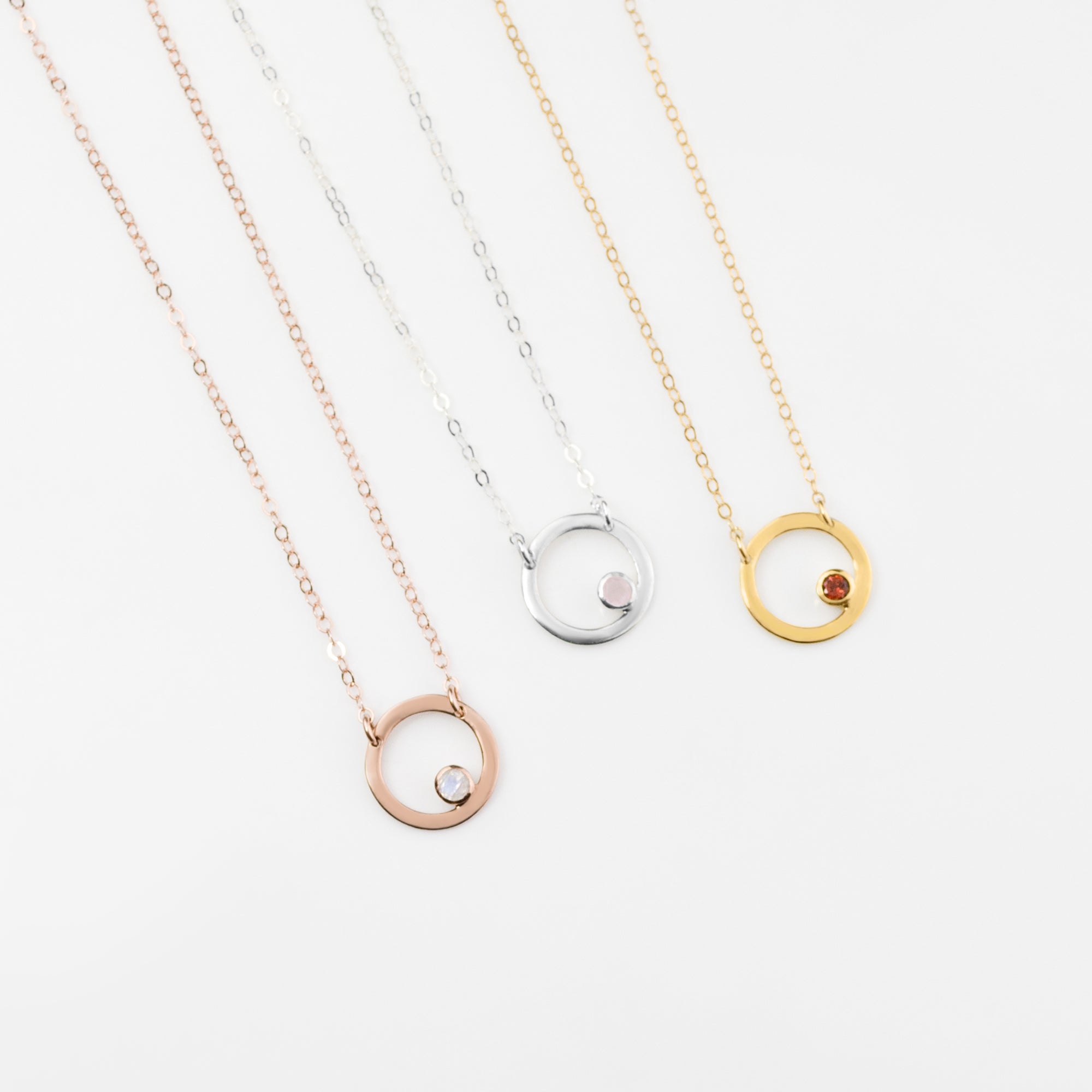 Rose gold filled circle moonstone birthstone necklace, Sterling silver open circle geometric necklace with pink chalcedony birthstone and a gold filled open circle necklace with garnet birthstone.