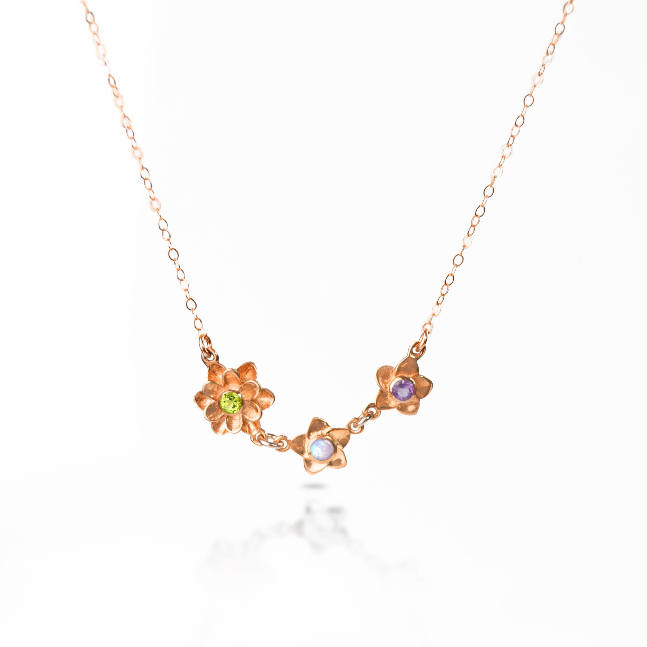 Mom of two bloom necklace in rose gold with peridot, moonstone and purple amethyst birthstones on a white background