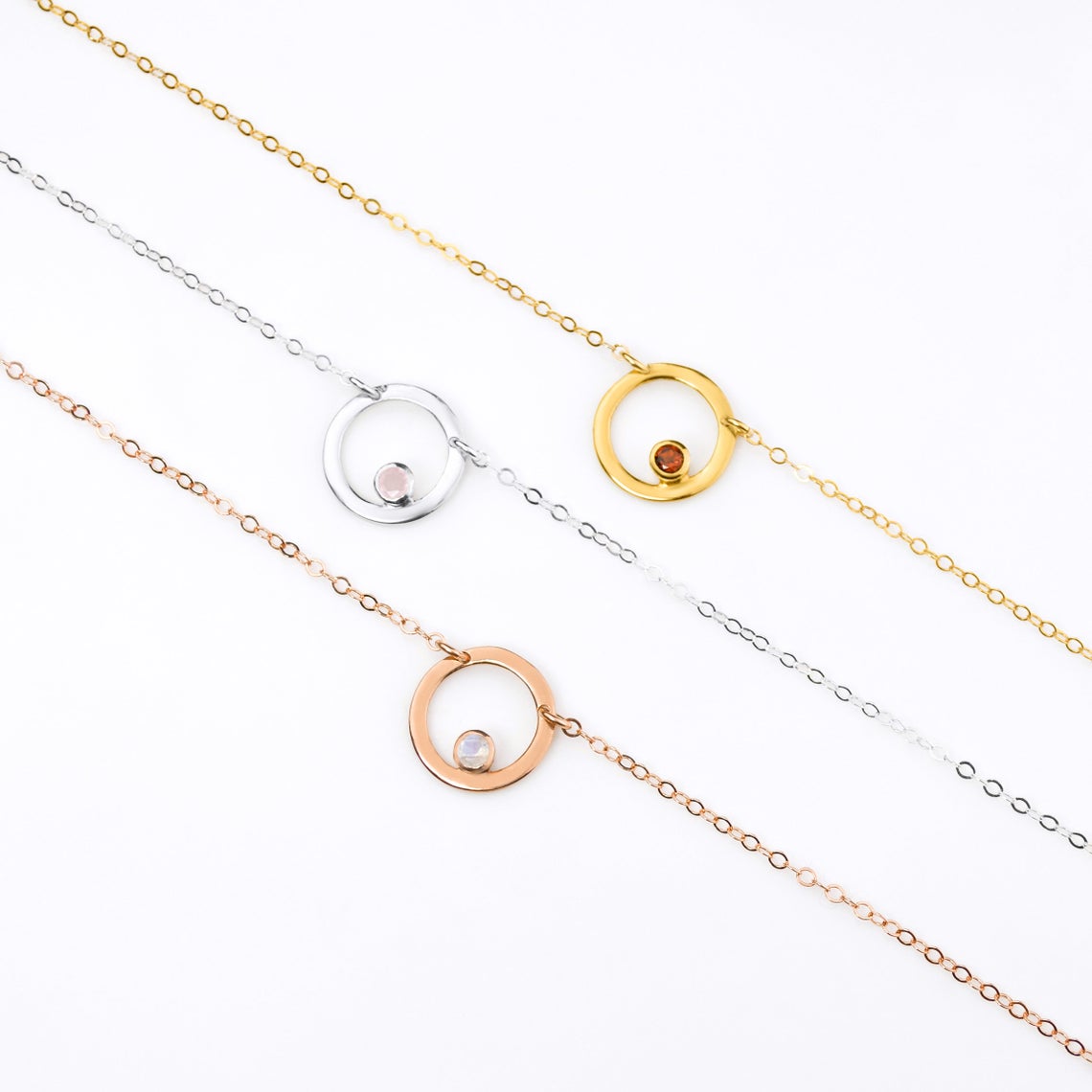 Rose gold filled circle moonstone birthstone necklace, Sterling silver open circle geometric necklace with pink chalcedony birthstone and a gold filled open circle necklace with garnet birthstone.