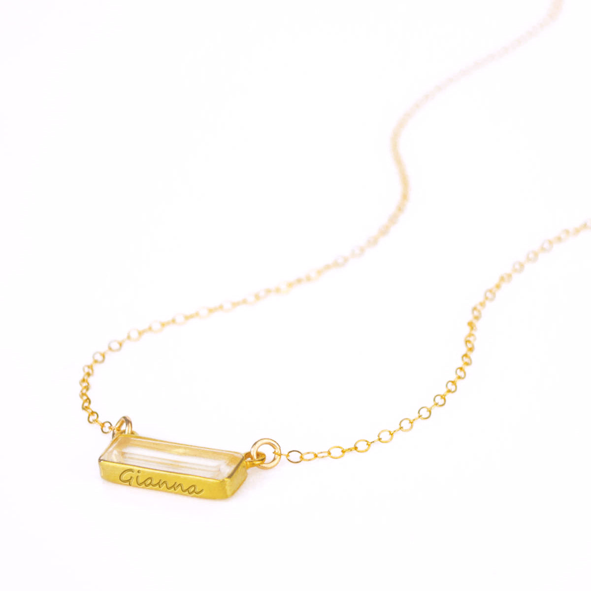 Single gold filled cable chain with horizontal clear quartz birthstone and secret message engraved on bottom of bar in script font