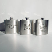 Three custom engraved stainless steel flasks in with different designs: name and message monogram, best man wreath design and best papa ever design. Fantastic personalized gift for party, wedding, christmas, birthday for dad, grandpa, husband or boyfriend.