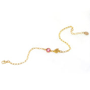 Gold filled double leaf charm with initial engraved and ruby birthstone on a white background. Ruby gemstone charm name