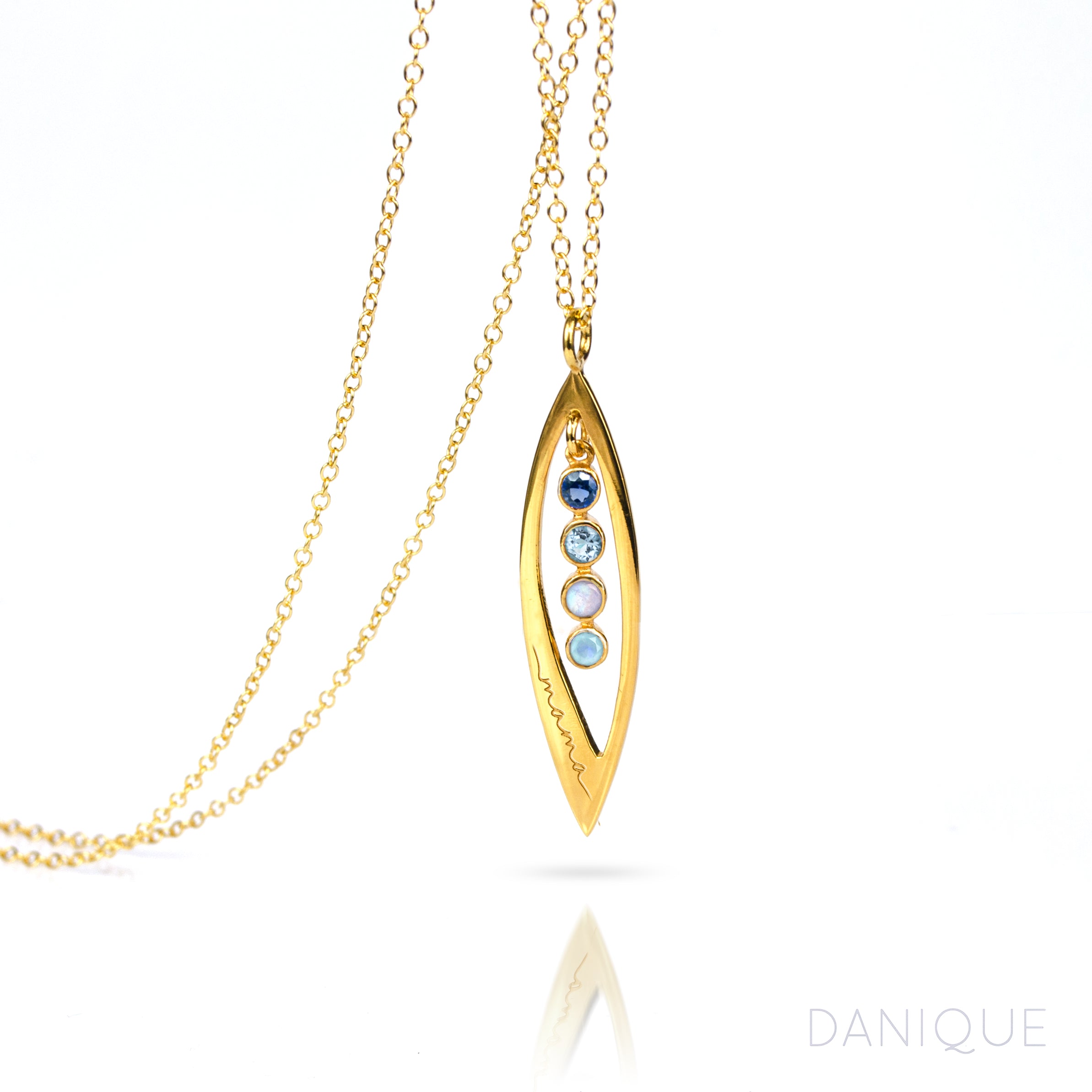 Gold filled mothers family tree necklace with open leaf pendant featuring kyanite, blue topaz, moonstone and aqua chalcedony birthstones with mama engraving on white background