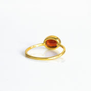 a rear view of the gold garnet ring shown on white background. stackable! Stacking rings, bezel set, small oval, tiny oval, dainty oval, birthstone rings, sterling silver stamp, birthstone ring, birthstone jewelry, red gemstone, red birthstone, january birthstone, january gemstone, stack set, stacking rings, gemstone ring, birthstone ring, mother's day gift for her, gift for mom, gift for fiance, gift for girlfriend, wedding jewelry, bridesmaid jewelry, anniversary jewelry, anniversary gift, birthday gift,