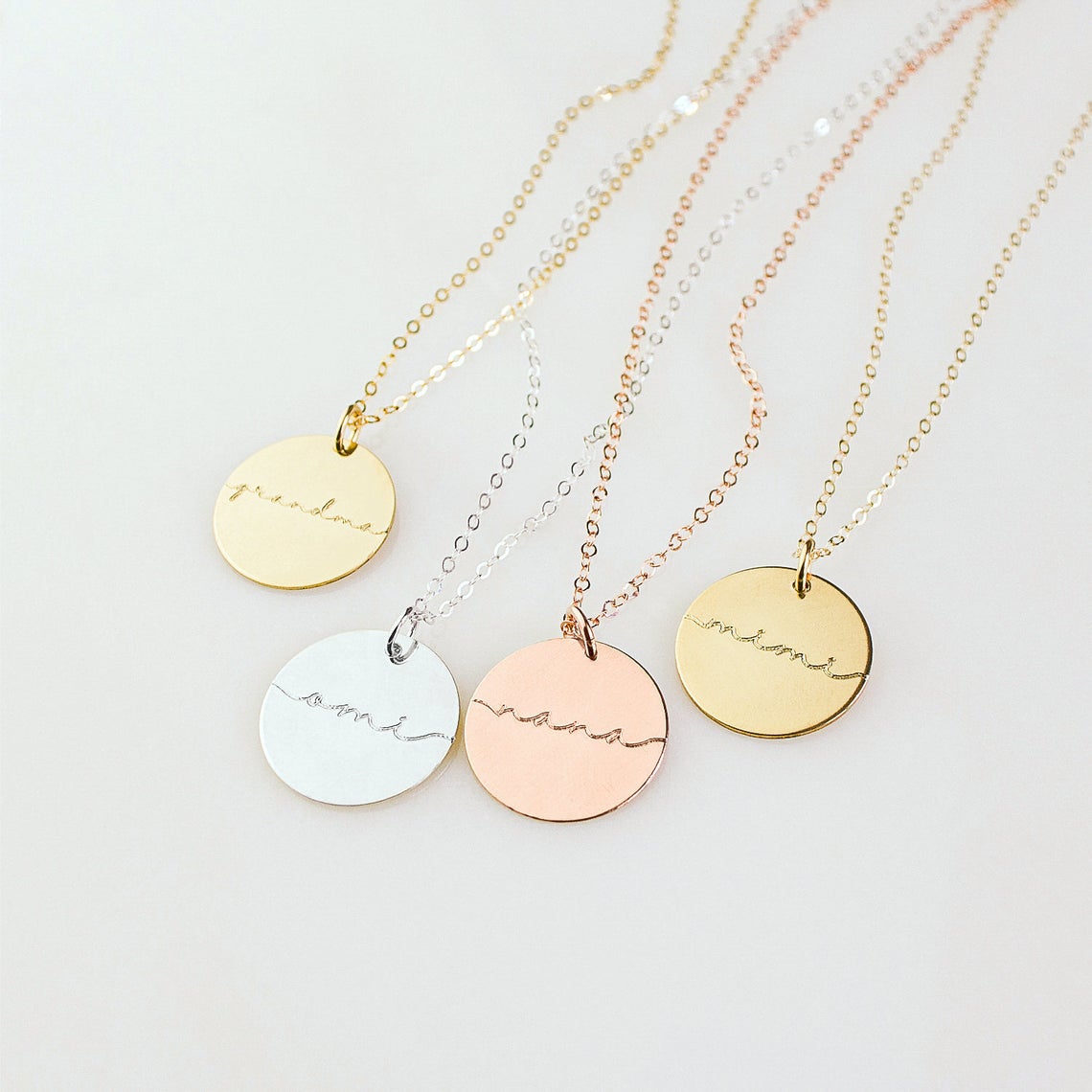 Mama  grandma 19mm disc necklaces come in rose gold filled, sterling silver or gold filled. Necklaces from left to right are gold plated, sterling silver, rose gold plated, gold plated