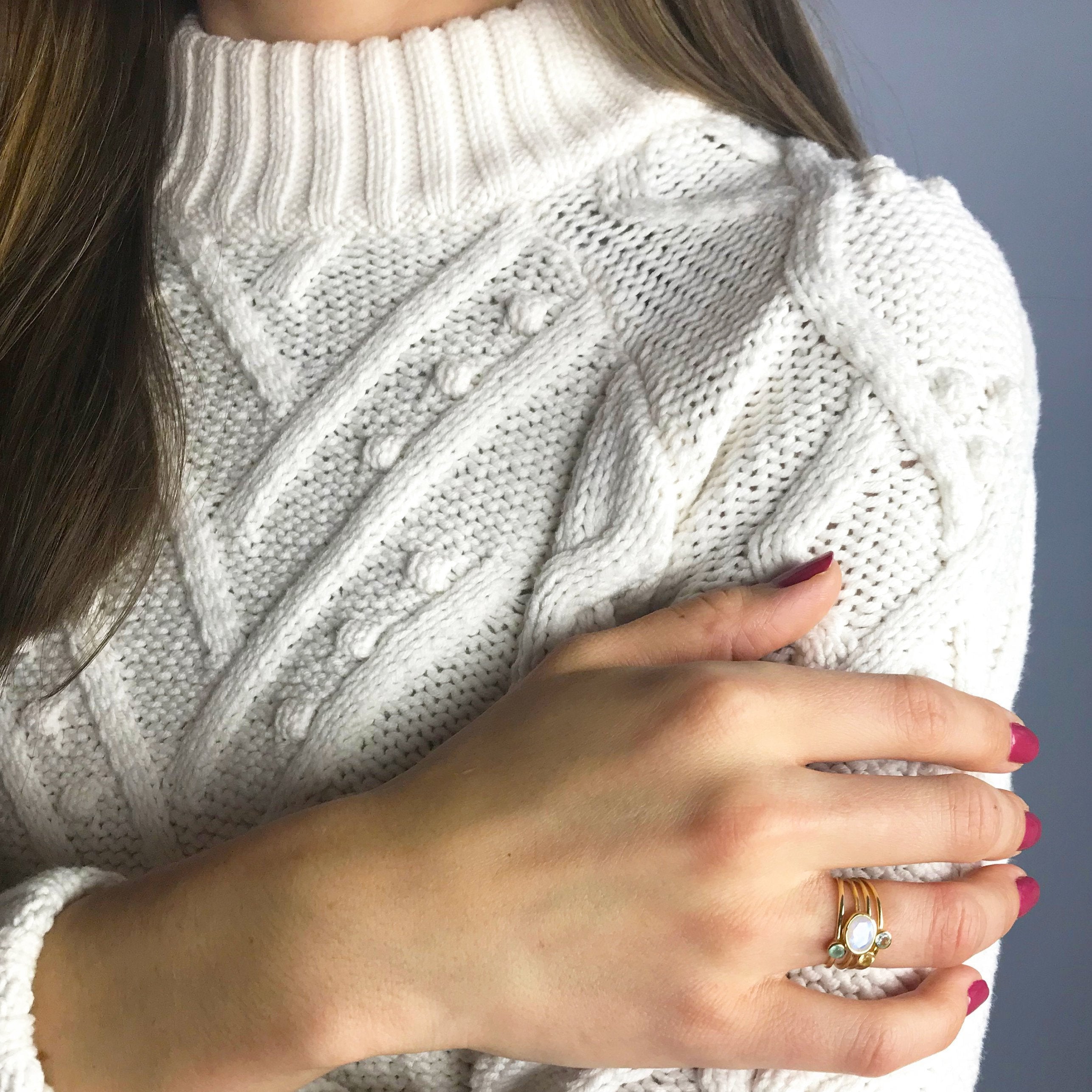 Model stylishly wearing a moonstone oval with peridot and purple amethyst set in gold.
