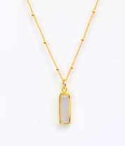 Gold filled satellite chain with June moonstone birthstone on white background.