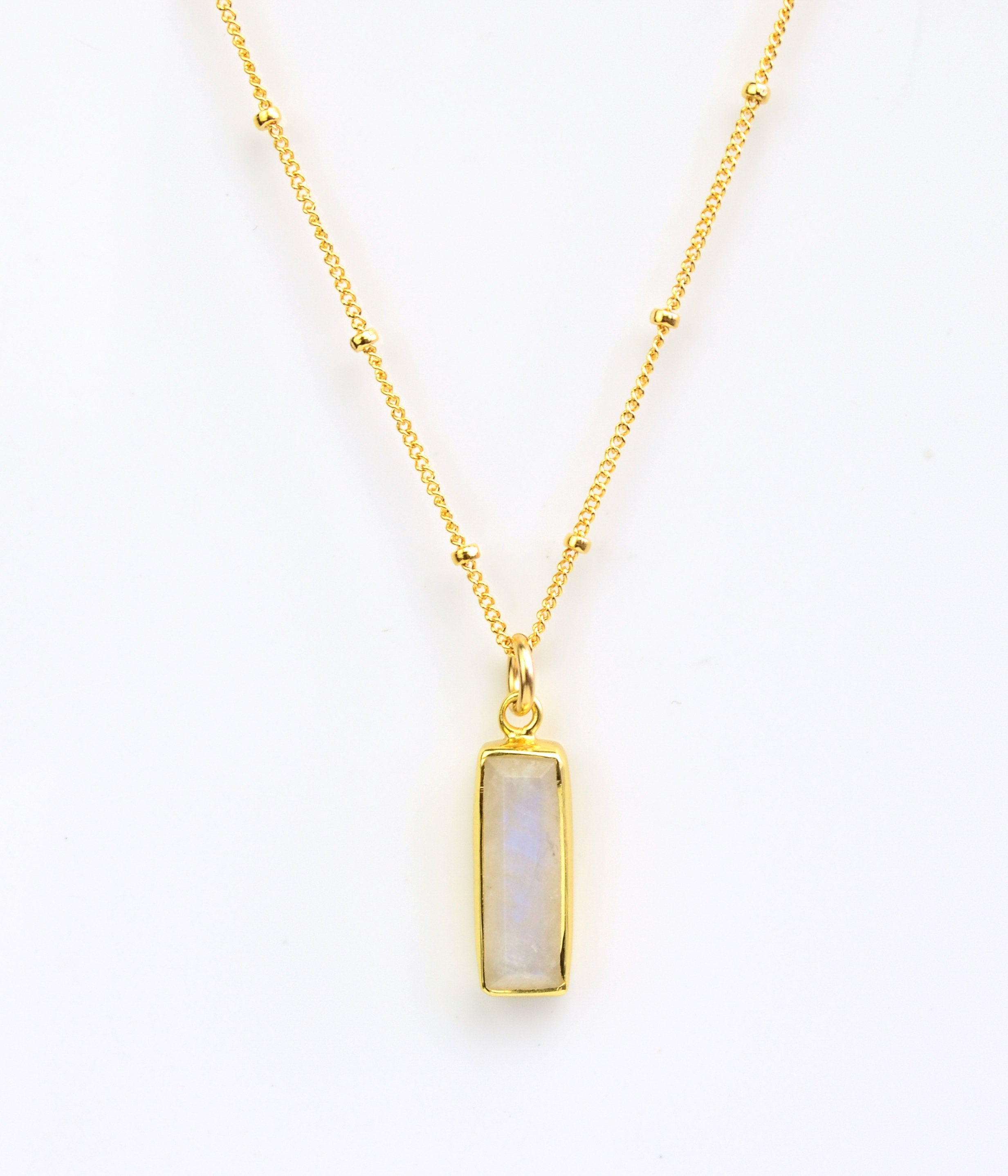 Gold filled satellite chain with June moonstone birthstone on white background.