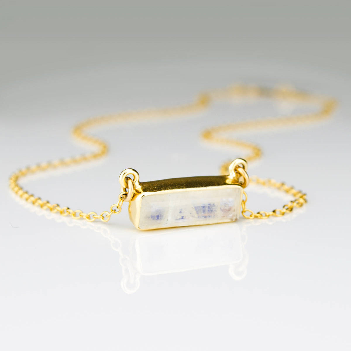June Birthstone rainbow moonstone horizontal bar necklace with a gold filled chain.