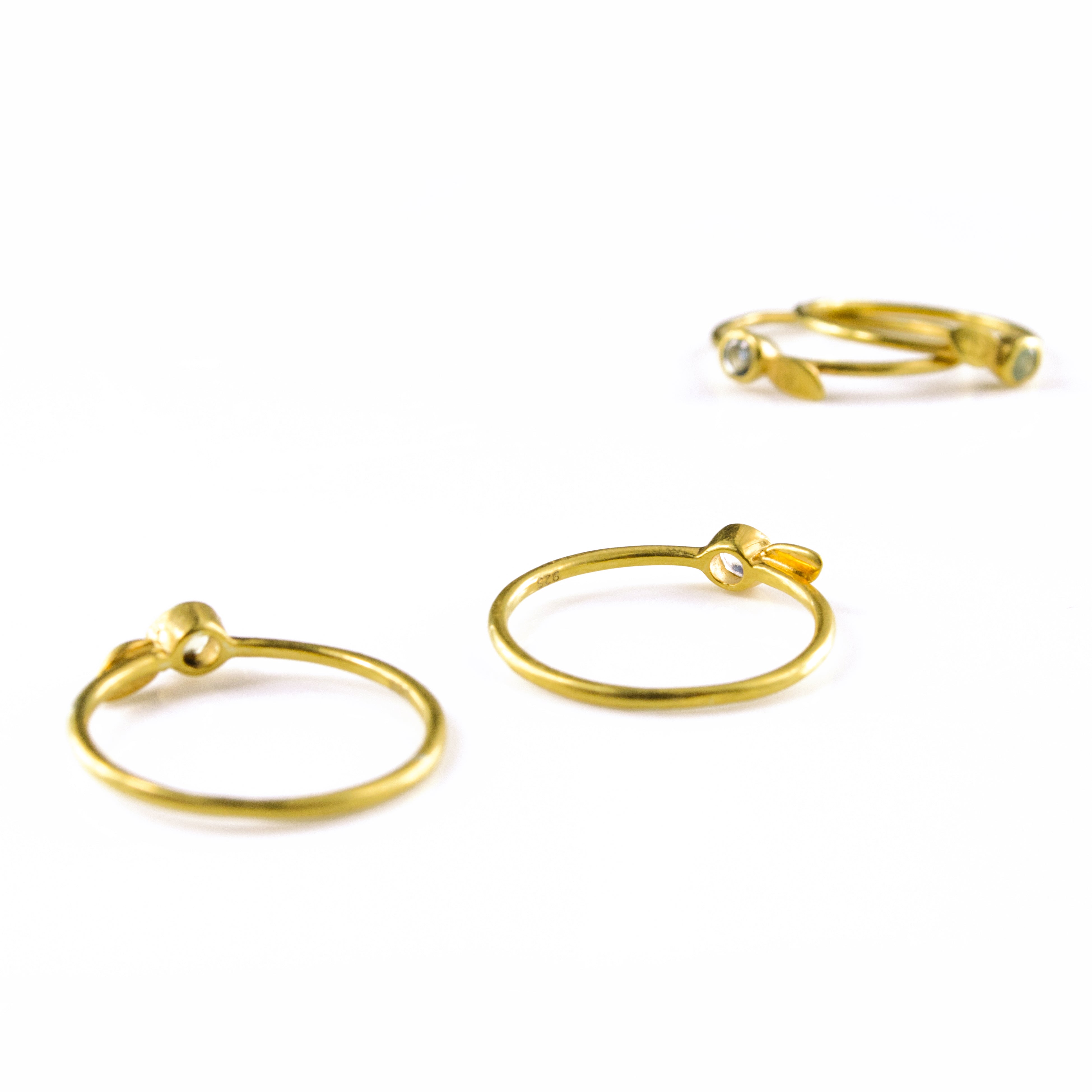 Backs and underside of the dainty stacking rings. Gold 3mm birthstone leaf initial rings with natural gemstones