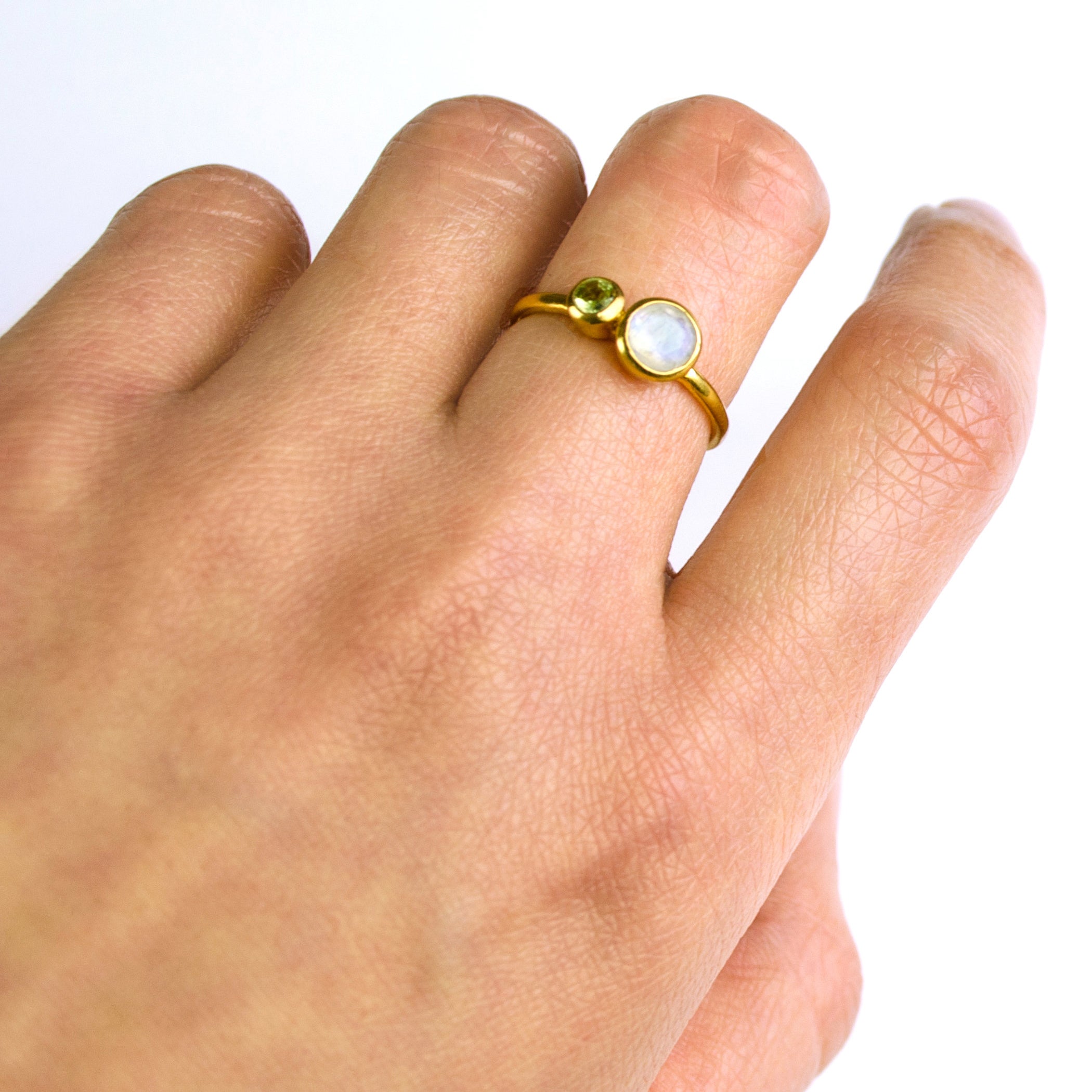 Model is wearing the mothers duel bezel set ring in gold filled featuring a 5mm moonstone and 3mm peridot birthstones.