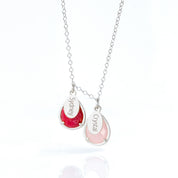 Silver prong teardrop necklace with two birthstones, ruby and pink chalcedony with engraved name tags.