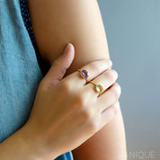 Model is stylishly pairing gold plated purple and green amethyst rings representing february birthstone. Purple amethyst ring, february birthstone jewelry, vibrant purple gemstone ring, Oval faceted Topaz, Bezel set ring, 18k vermeil gold, Sterling silver ring, amethyst gift, february birthday gift, purple ring for her, stacking ring, stackable ring