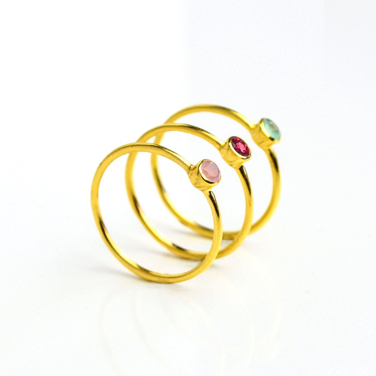 three gold plated dainty 3mm gemstone rings featuring aqua chalcedony, garnet and pink chalcedony. On white background. 925 sterling silver, birthstone ring, stacking ring, stackable, birthstone jewelry, facet gemstone