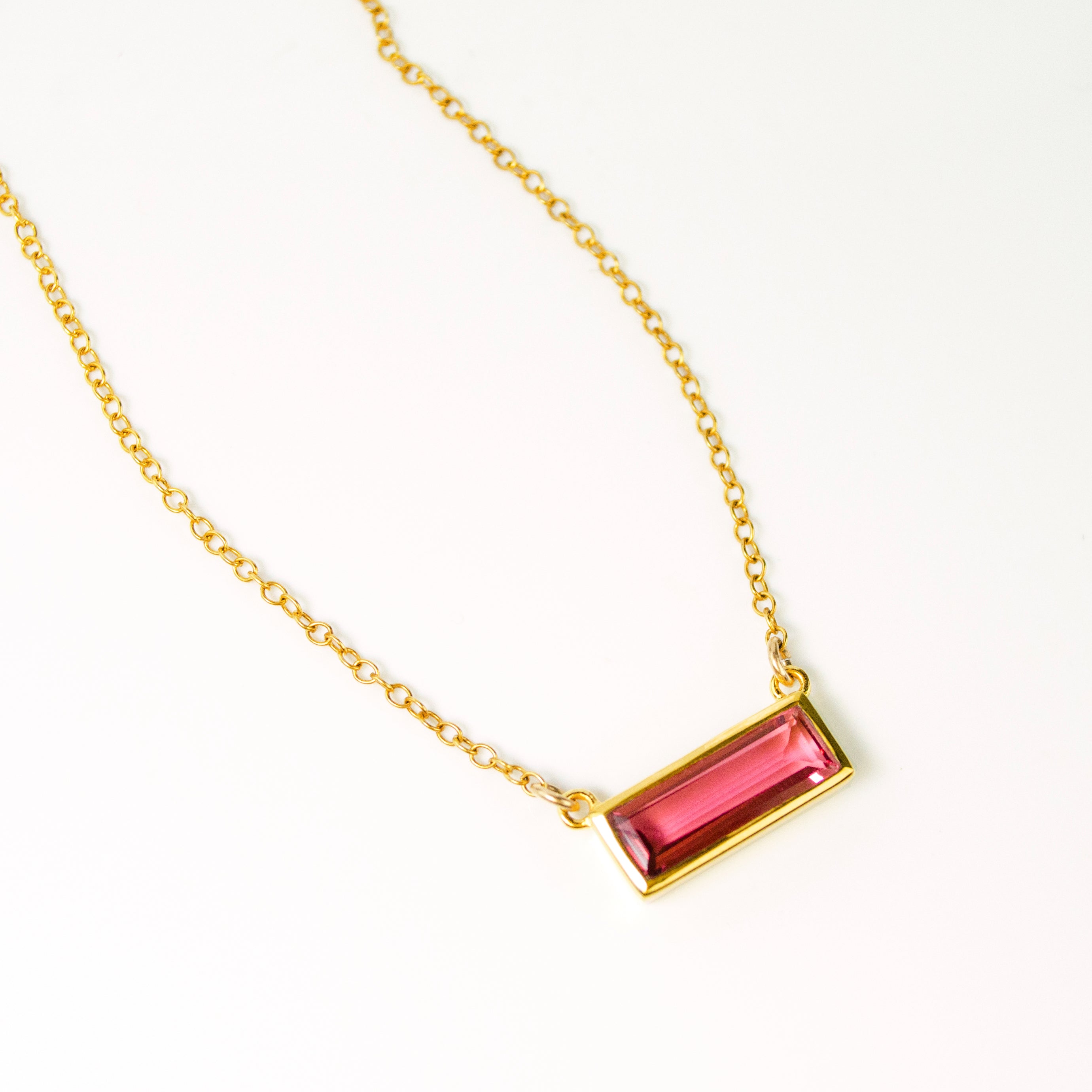 Single gold filled cable chain with ruby quartz horizontal bar adira necklace july birthstone on white background