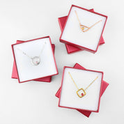 Gifting ready! Gift giving ready. Each piece will come packaged in our signature Danique Jewelry Gift box. Collection of silver open circle with pink chalcedony, rose gold triangle with citrine birthstone or gold square with ruby birthstone.