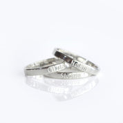 Pair of sterling silver 3mm engraved rings displayed together on a white background. Slim minimalist bands personalized with text engraving such as names, dates, or coordinates, making them perfect for couple’s rings, promise rings, or wedding bands. This dainty design is unisex, handcrafted, and available in sterling silver, gold vermeil, and rose gold vermeil.