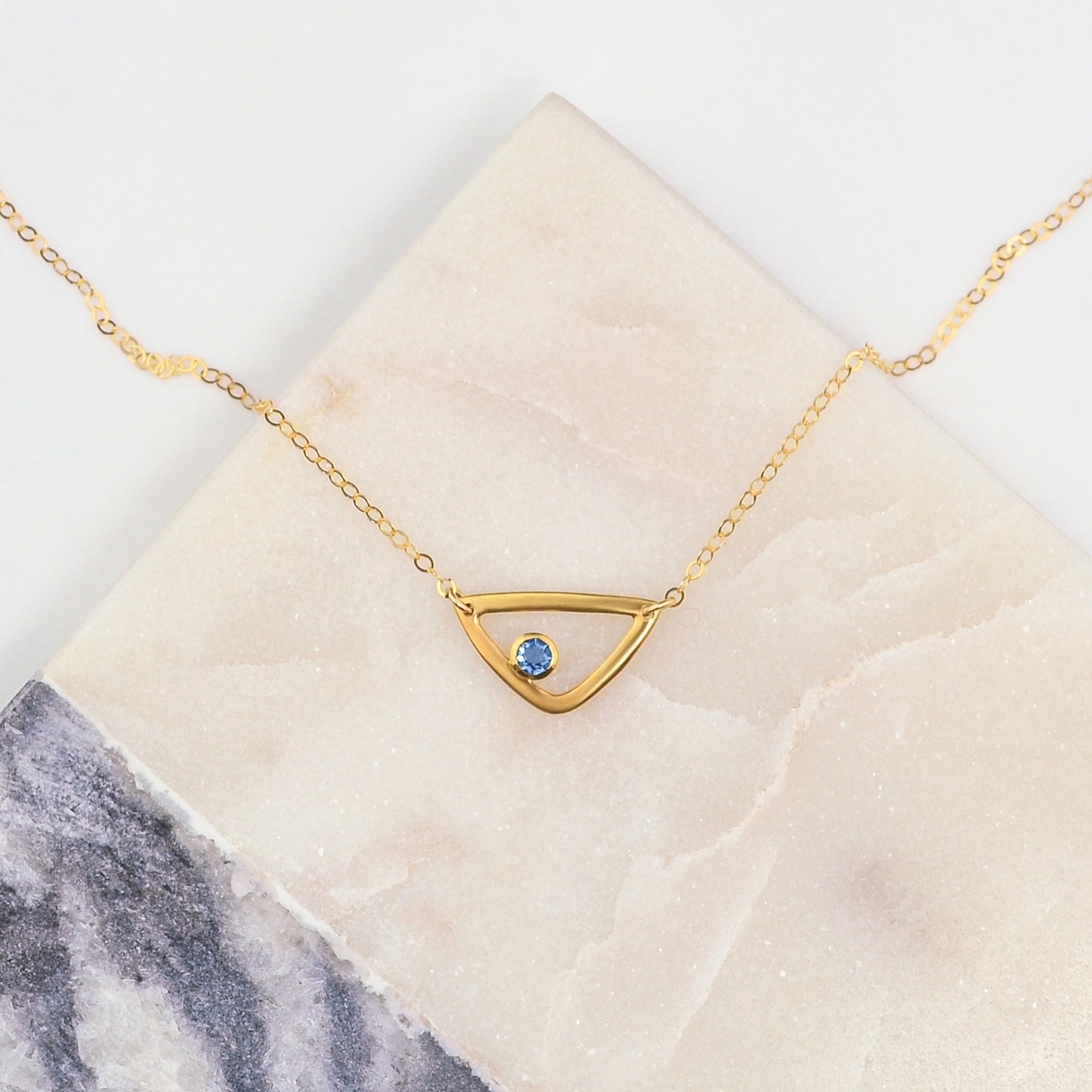 Single gold filled triangle geometric necklace with kyanite birthstone for september.