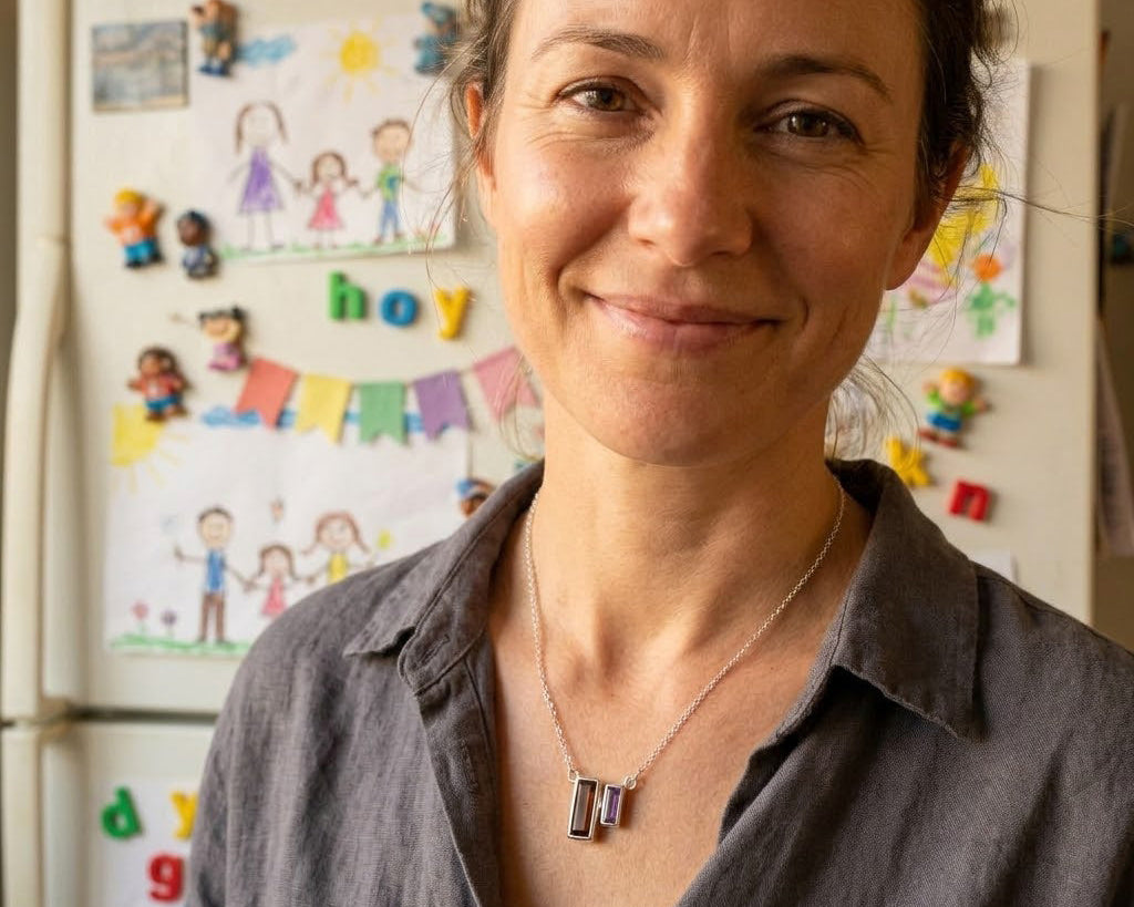 Mom wearing a custom birthstone bar necklace with baguette stones, a meaningful personalized jewelry gift for Mother’s Day, birthdays, or grandma in sterling silver, gold, or rose gold.