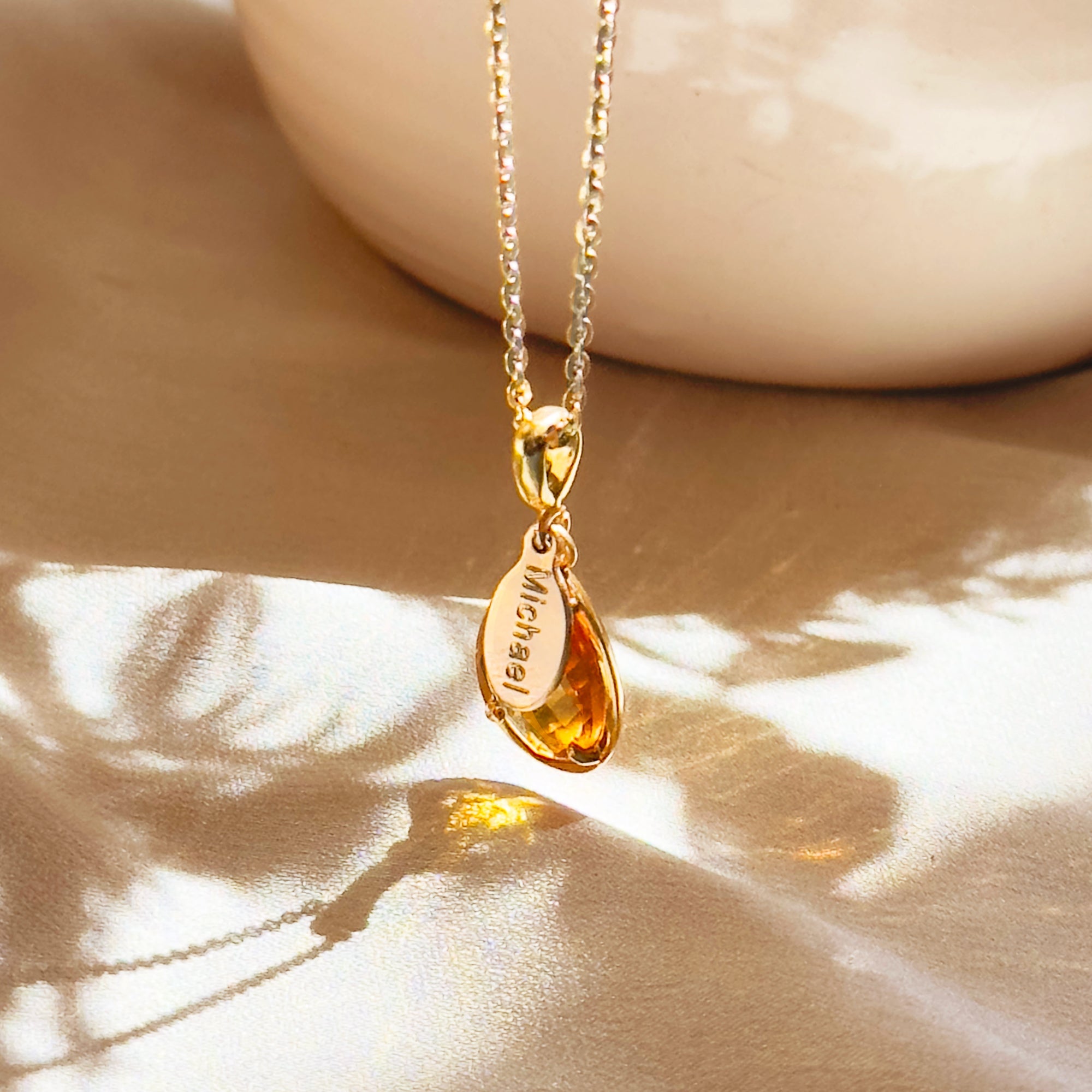 Golden citrine November birthstone necklace featuring a faceted teardrop gemstone in 18k gold vermeil with a hidden engraved name “Michael.” A warm, sunny keepsake symbolizing joy, abundance, and success.