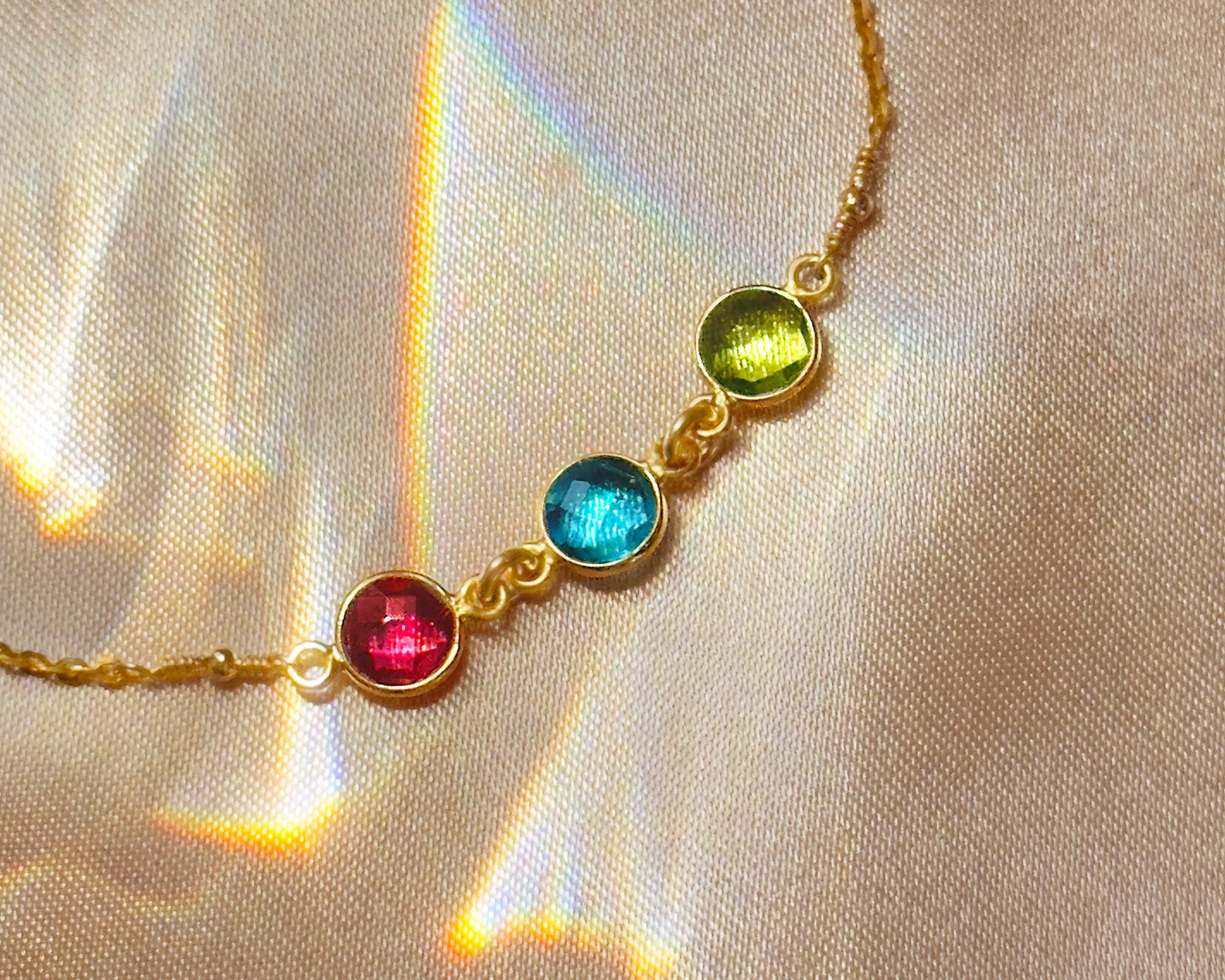 Taylor Swift inspired birthstone anklet with ruby, kyanite, and peridot stones. Custom bestie jewelry and friendship gift in sterling silver, yellow gold, or rose gold for birthdays or holidays.