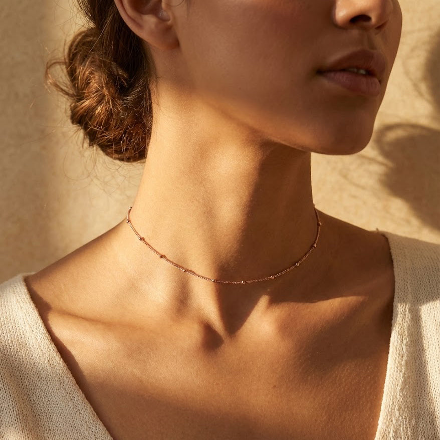 Dainty dew drops satellite choker necklace on model, minimalist gold choker necklace with tiny bead accents, delicate layering necklace for women, everyday dainty gold jewelry, minimalist satellite chain choker