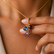 Custom cascade birthstone necklace worn on model with colorful round gemstones representing children, grandchildren, or loved ones.